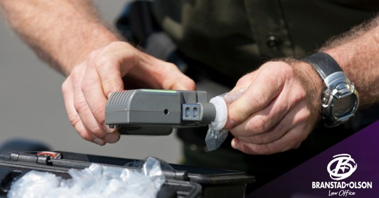 Law enforcement officer preparing a breathalyzer test